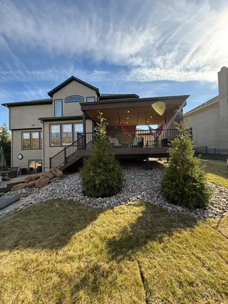 Covered composite deck with outdoor living area and landscaping