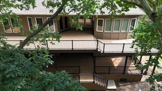 Two-story deck with black metal railings and stairs in Shawnee